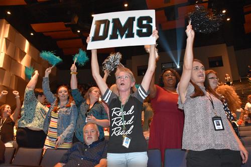 School spirit sign with cheering teachers